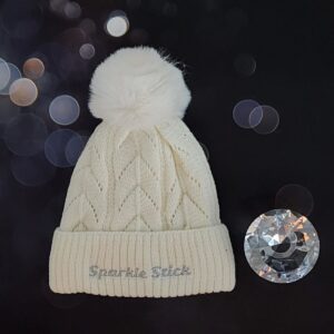 Cream cable knit beanie with pom-pom.