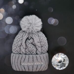 Gray cable knit beanie with pompom.