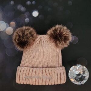 Pink knit beanie with two pom-poms.