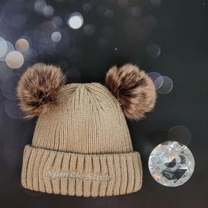 Beige knit beanie with pom-poms.