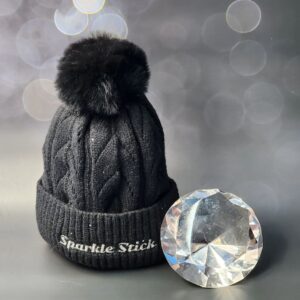 Black pom-pom beanie and diamond.